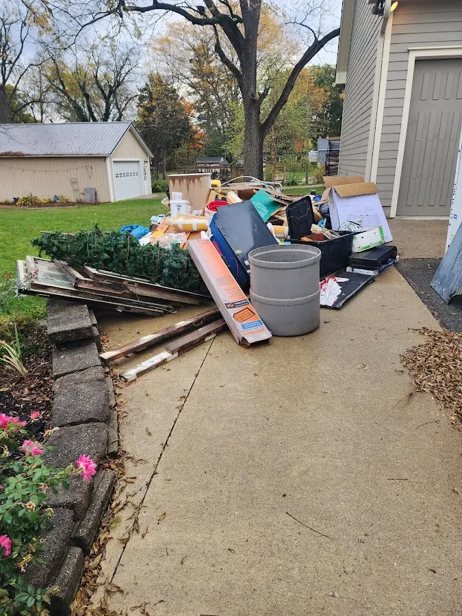 Dumpster being loaded with debris for Commercial Dumpster Rental in Loveland